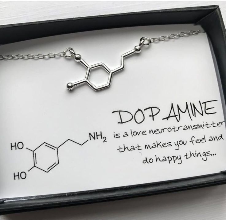 a necklace with the words dopamine written on it in black ink and silver chain