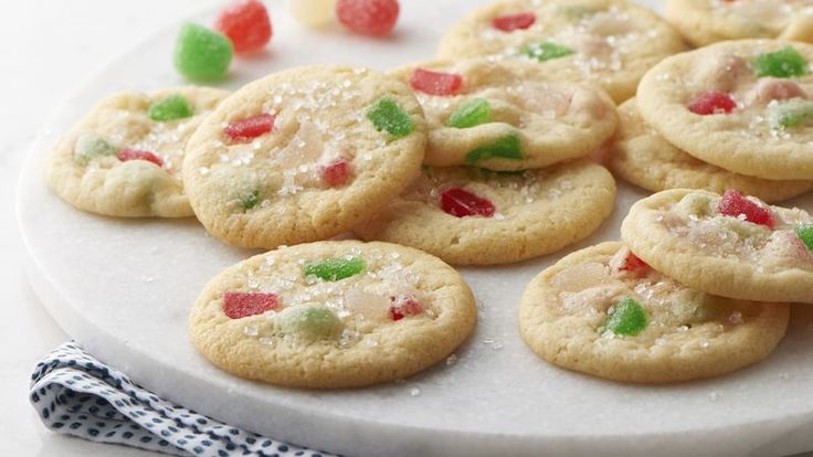 a white plate topped with cookies covered in candy