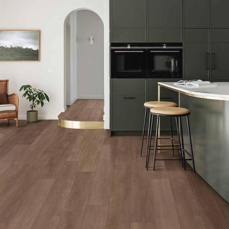 a kitchen with wood floors and green cabinets