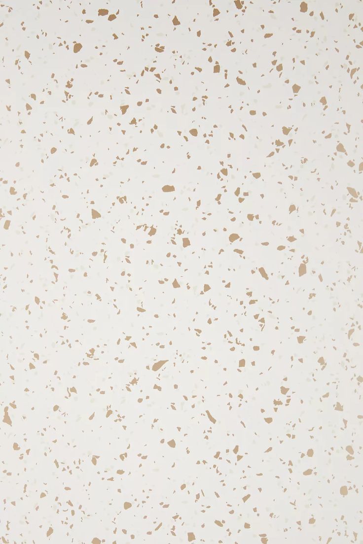 a white and brown speckled wallpaper with lots of small dots on the surface