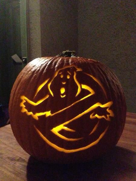 a carved pumpkin sitting on top of a wooden table