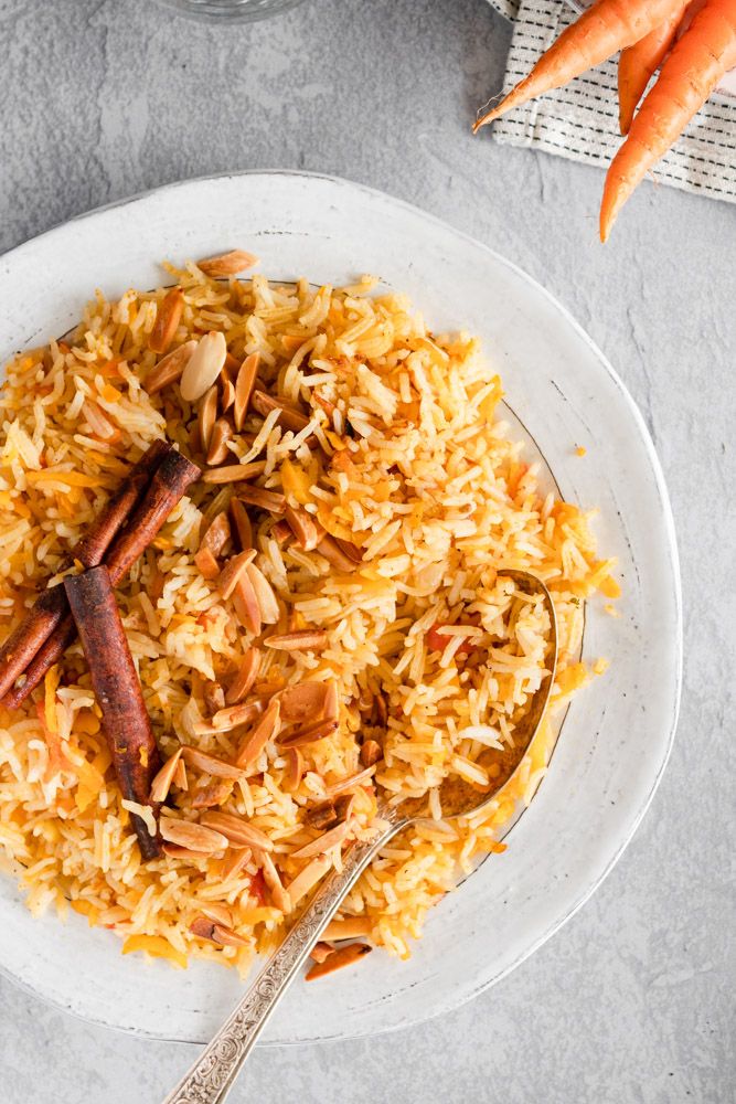 a white plate topped with rice and carrots