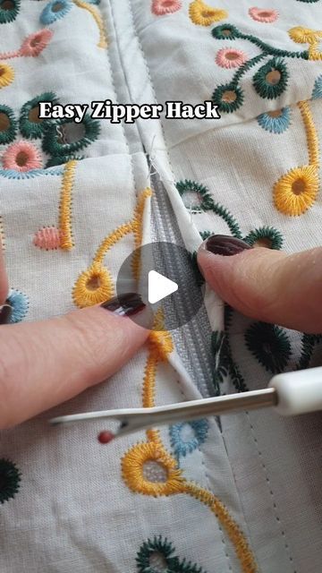 someone using scissors to cut fabric with crochet on the bottom and side of it