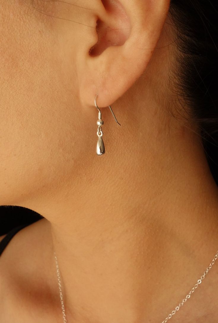 "These teardrops dangle from sterling silver ear wires for a beautifully simple look.  Perfect for everyday. Teardrop measures 10mmx4mm or 3/8 x 2/8\" and total length of  earrings or 1\" for 26mm from the top of the ear wire to the bottom of the tear drop. This earring is also available in 24K gold plate over solid sterling silver teardrop, with a gold filled ear wire. Choose either version in the Material drop down. Please read my policies page before purchasing. Your item comes wonderfully boxed and wrapped so you can give it as a gift - or enjoy opening it as a gift yourself!  ----------------------------------------------------------------- Visit my entire shop at http://www.popsicledrum.etsy.com -------------------------------------------------------------" Silver Teardrop Earrings, Simple Silver Earrings, Small Drop Earrings, Drop Earrings Silver, Silver Jewelry Earrings, Dope Jewelry, Silver Dangle Earrings, Mom Gifts, Dangling Earrings