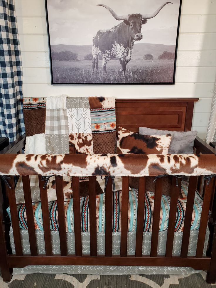 a brown and white cow print baby bedding set