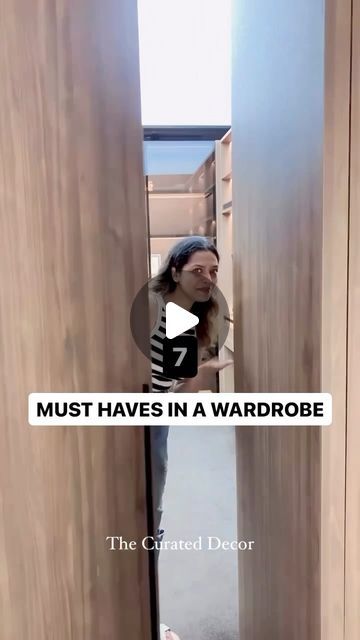 a woman standing in an open doorway with the caption must haves in a wardrobe