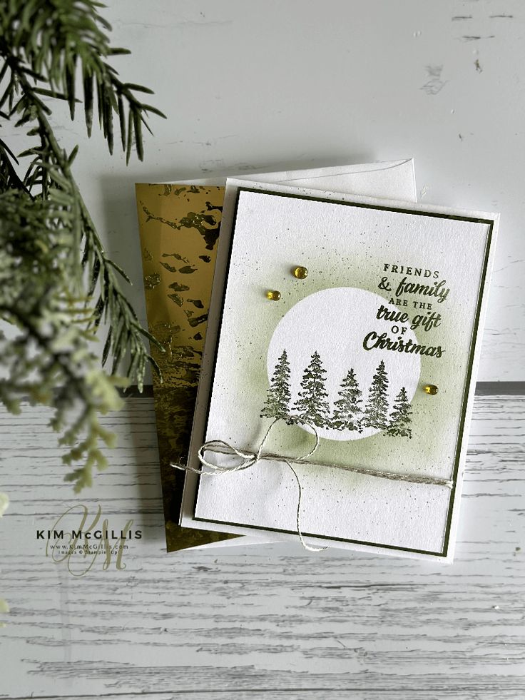 two christmas cards with pine trees on them