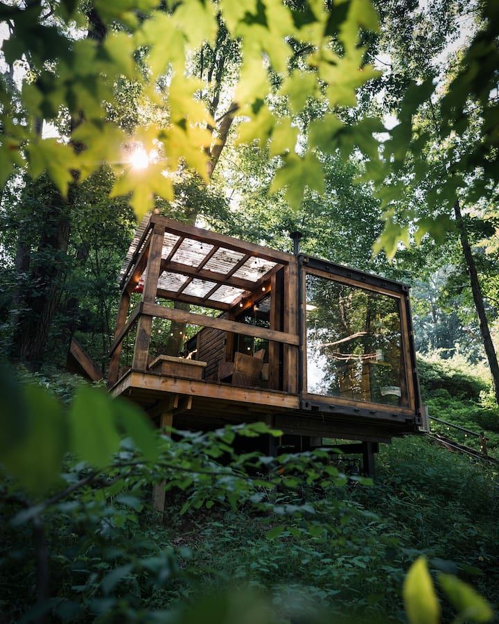 a wooden structure in the middle of some trees