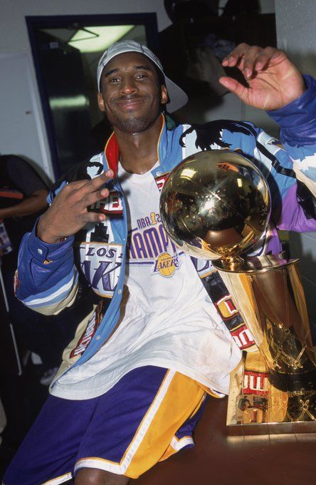 the basketball player is posing with his trophy