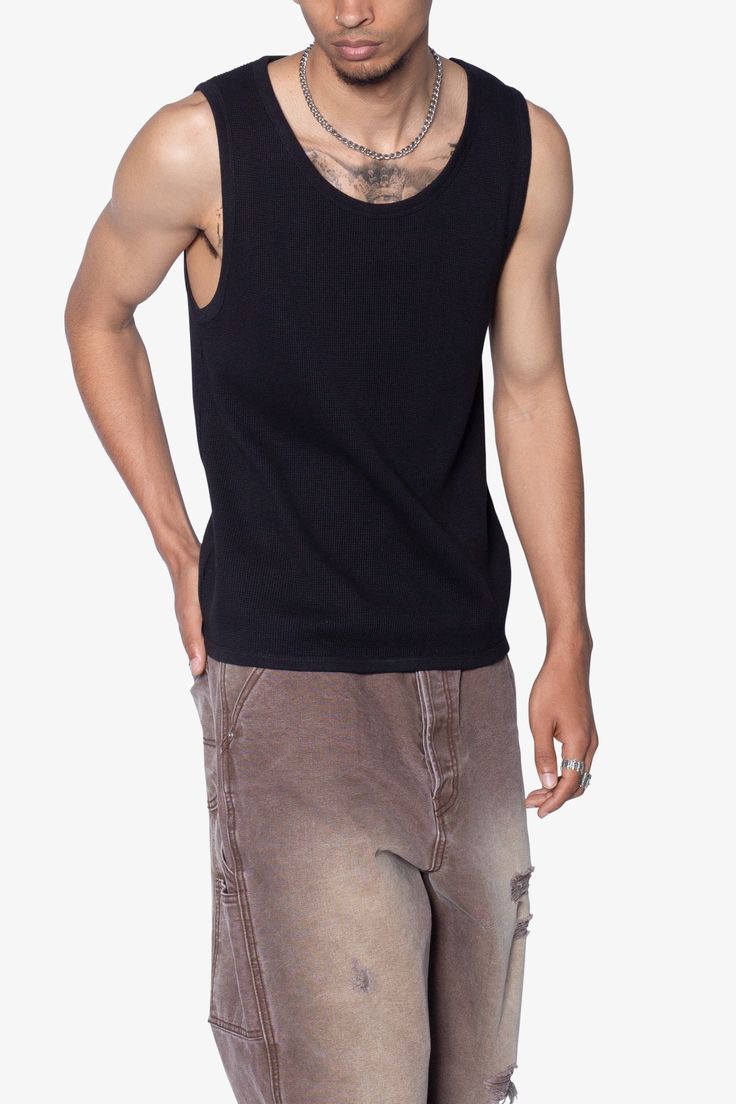 the Waffle Knit Tank is a 100% cotton tank is perfect as a base layer or worn alone. the tank features taping at the neck and arm openings, a flat hem, and is constructed in a ribbed material. details flat hem 100% ribbed cotton fabric Model is 6’0, 140 lbs and wears a size medium Casual Streetwear Tops With Tank Straps, Casual Tank Strap Tops For Streetwear, Urban Crew Neck Cotton Tank Top, Urban Cotton Crew Neck Tank Top, Urban Style Cotton Crew Neck Tank Top, Cotton Sweater Vest For Layering, Solid Cotton Sweater Vest For Layering, Cotton Tank Top With Ribbed Neckline For Summer, Summer Cotton Tank Top With Ribbed Neckline