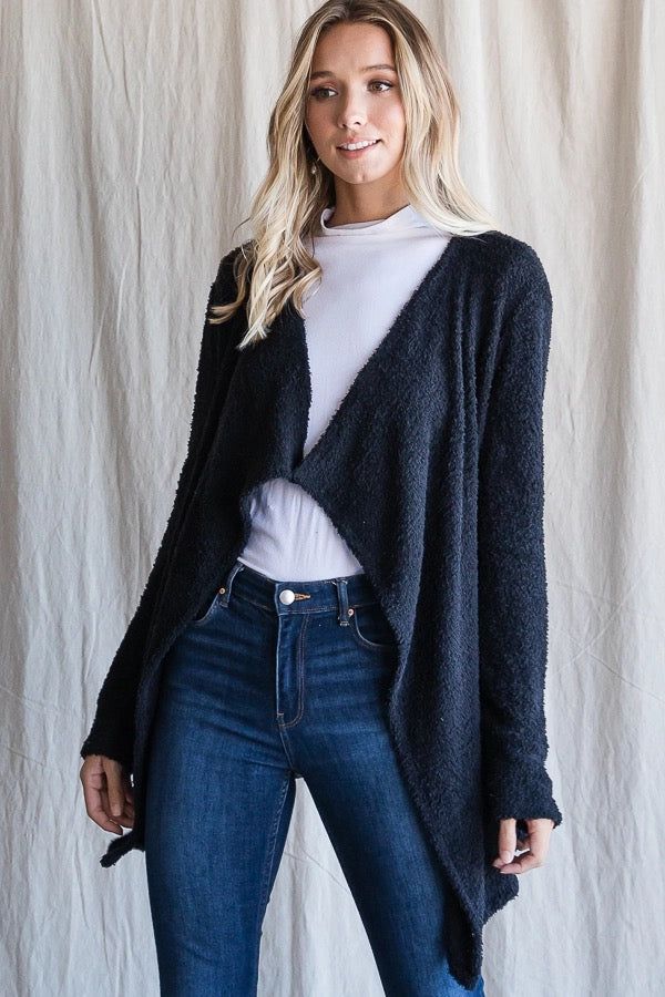 The softest cardigan you will ever wear. It is an open, asymmetrical cut that gives for a flattering look. It is a fuzzy material with a lightweight feel. Great to throw on over a simple tee on chillier days. Model is 5'10" and wearing her true size Small. Small: Bust 20", Length 27" 100% Polyester Made in the USA Asymmetrical Cut, Soft Cardigan, Simple Tees, Open Cardigan, Cardigan Tops, Denim Jumpsuit, Soft Black, Bottom Clothes, Small Bust