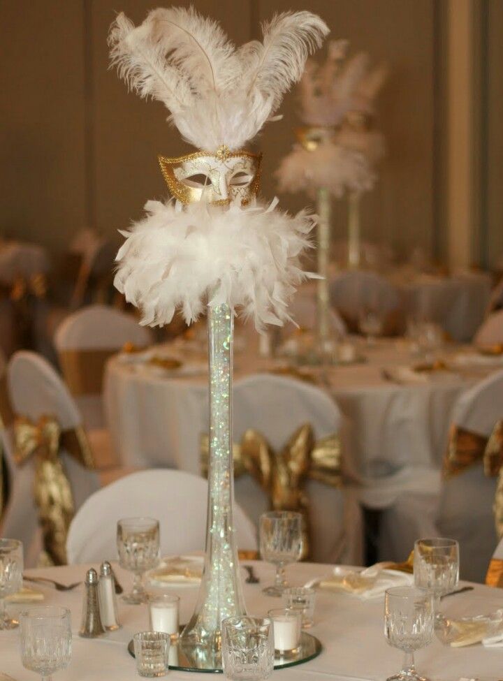 an image of a table setting with white and gold decorations on it's centerpiece