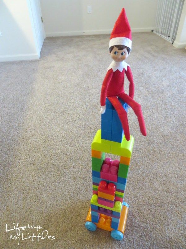 an elf sitting on top of a building made out of blocks