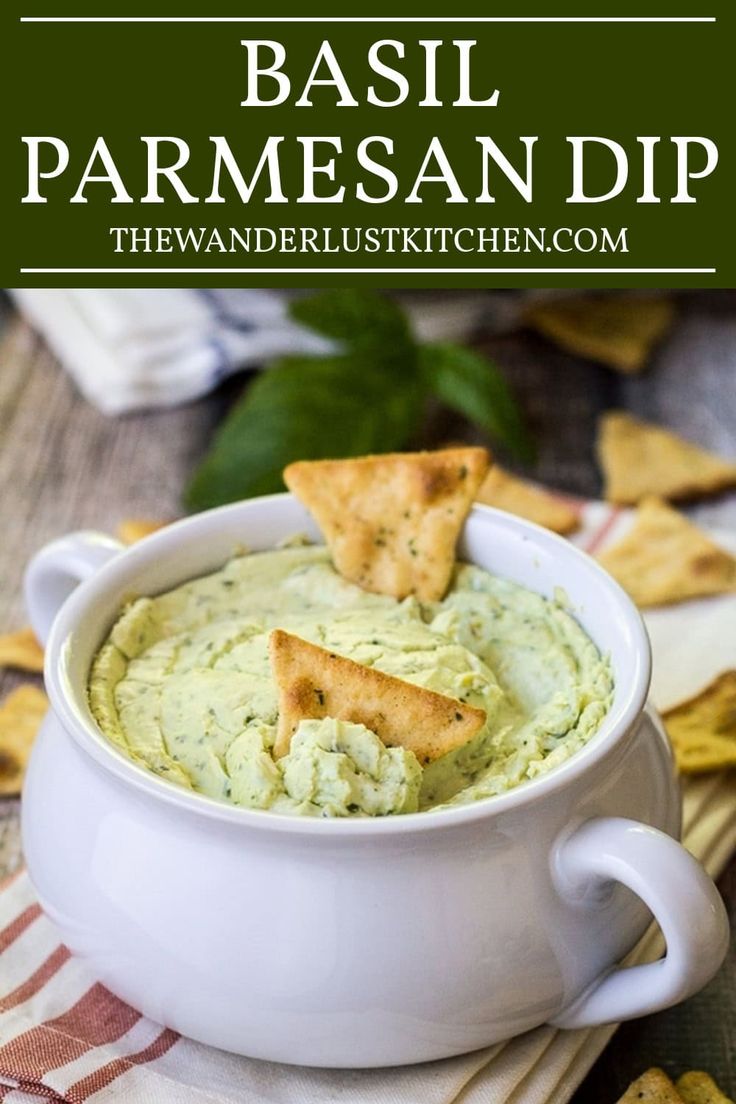 a white bowl filled with hummus and crackers