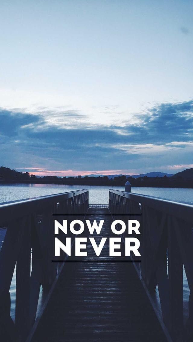 a pier with the words now or never over it