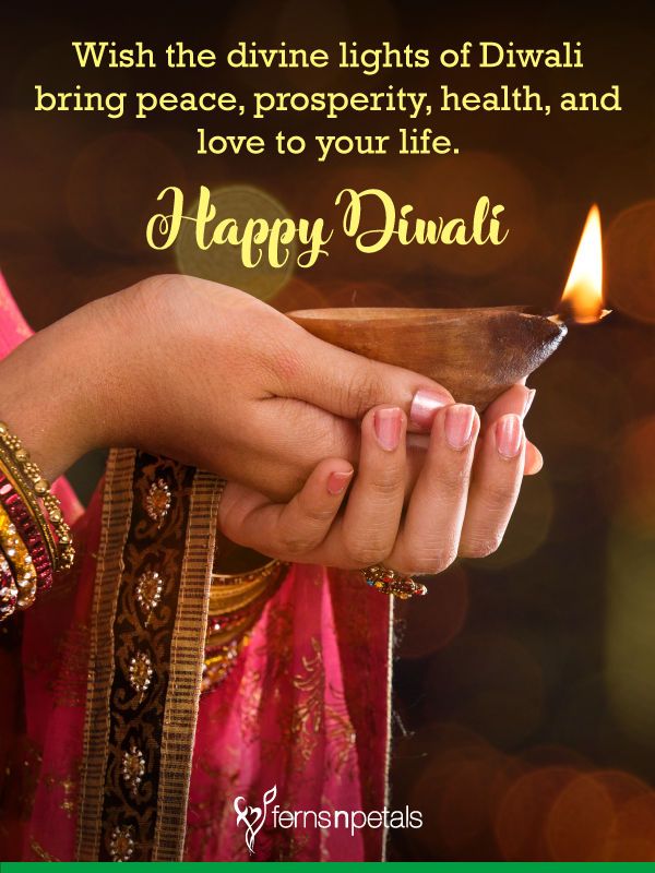 a person holding a small bowl with a lit candle in it and the words happy diwal