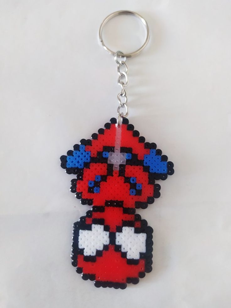 a pixel keychain that has been made to look like an old school video game character