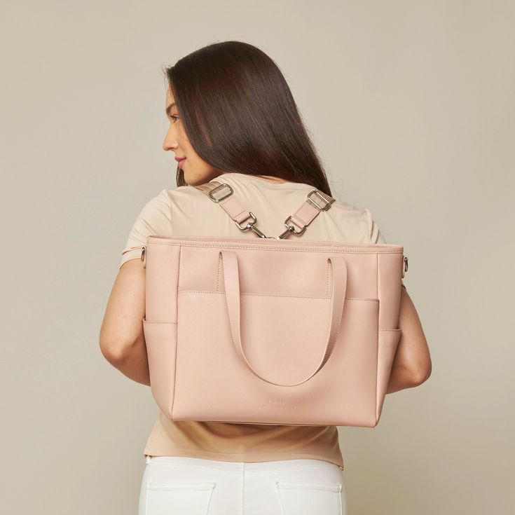 This structured tote is the ultimate do-it-all bag that you deserve. It's the perfect carryall for work, travel, and anywhere your day brings you. It features a spacious and organized interior for your essentials, a padded compartment for your laptop, side pockets for your drinks, and you can convert it into a backpack or crossbody. Crafted from premium American Saffiano leather that's waterproof and scratch-resistant, the Transform Tote will stay just as beautiful through all your travels and a On-the-go Laptop Bag With Detachable Double Handle, Versatile Tote Box Bag For Travel, Travel Tote Box Bag With Removable Pouch, Versatile Briefcase With Removable Pouch, Everyday Travel Shoulder Bag With Detachable Handle, Laptop Satchel Bag With Detachable Handle For Everyday Use, Modern Travel Bag With Detachable Handle For Everyday, Shopping Diaper Bag With Adjustable Strap Tote, Versatile Double Handle Diaper Bag For Errands