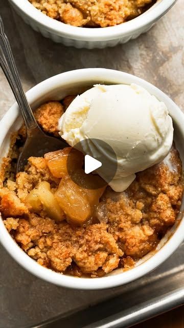 two bowls filled with apple crisp and ice cream