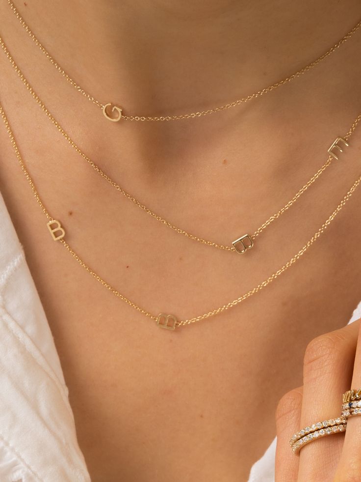 This 14K yellow gold custom made asymmetrical letter necklace is made with six (6) initials of your choice. You can also choose to add a bezeled baguette or round diamond. Great to display your own initials, your children's initials for a new mom, or anyone else you want to hold close to your heart. Available in chain lengths 16", 18", or adjustable 18" with loops at 16" and 17". Please note that custom jewelry is final sale. If you have any questions before placing your order, just email us! Everyday Yellow Gold Initial Necklace With Custom Name, Luxury Initial Pendant Name Necklace With Initials, Luxury Initial Pendant Necklace With Initials, Luxury Initial Pendant Name Necklace, 14k Gold Monogram Initial Necklace For Anniversary, Dainty 14k Gold Monogram Name Necklace, Luxury 14k Gold Monogram Necklace, Anniversary Yellow Gold Monogram Initial Necklace, 14k Gold Yellow Monogram Charm Necklace