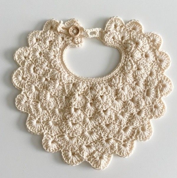 a crocheted bib is shown on a white surface