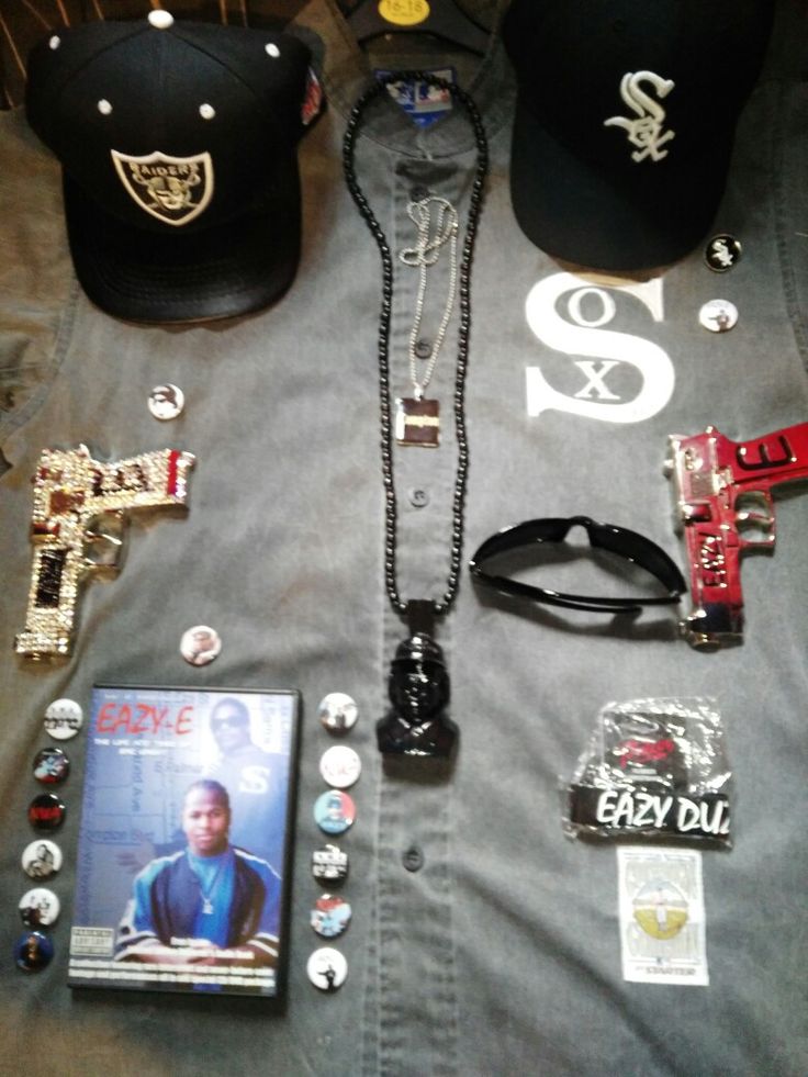 the contents of a man's outfit laid out on a bed with hats and other items