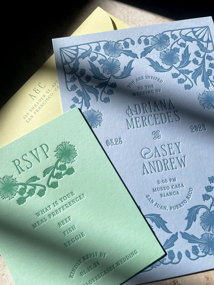 three different colored wedding cards on top of each other