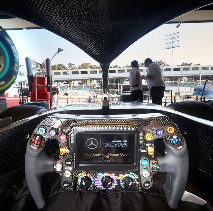 the interior of a car with steering wheel controls and dashboard buttons on display at an auto show