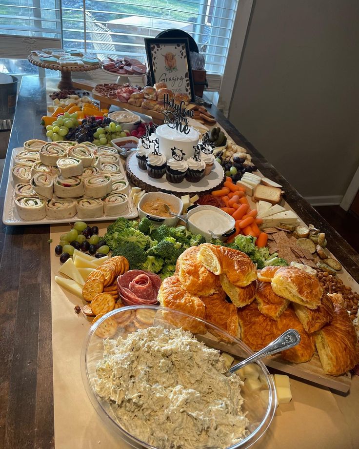 an assortment of food on a buffet table