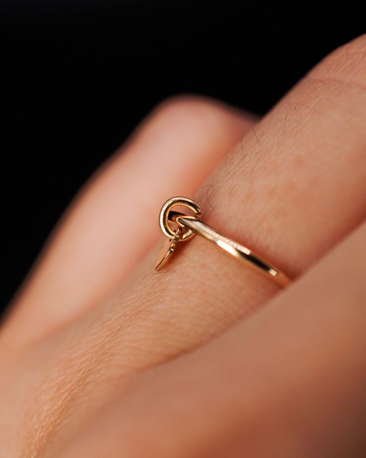 Introducing the Lover Charm Ring—a delicate and minimalist piece designed to capture the essence of simplicity and love. This handcrafted ring features a Thick, smooth ring made from 14k gold fill. Dangling gracefully from the band is a tiny heart charm, a subtle yet powerful symbol. Its minimalist design makes it a perfect accessory for any occasion, whether you're looking for a statement piece or a subtle addition to your everyday jewelry. This listing is for ONE single Charm Ring made up of: Thick Ring, Gold Ring Stack, Tiny Heart, Charm Rings, Handcrafted Rings, Charm Set, Everyday Jewelry, Stacking Rings, Heart Charm