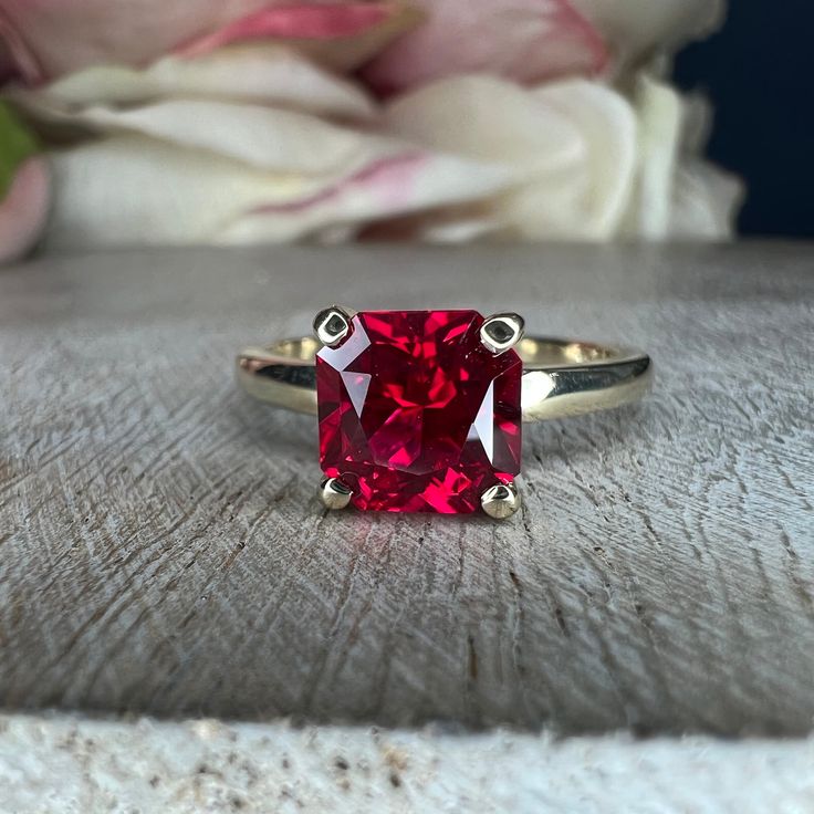 "This ring is a radiant cut lab created ruby with open u setting solitaire, 14k yellow gold #6217 This ring can be made with many different stone colors Message us for pricing on different color/type stones **Ruby is birthstone of July** -Approximate total carat weight: 2.10ctw diamond equivalent -Center Stone Size: approx. 1.75 ct diamond equivalent -Center Stone Shape: radiant 7x7mm -Gem Type: lab created ruby -Stone Clarity: AAA -Stone Color: red -Moh's Scale: 9 hardness -Metal Type and Purit Classic Ruby Ring With Asscher Cut, Classic Asscher Cut Ruby Ring For Anniversary, Formal Radiant Cut Ruby Ring With Center Stone, Formal Asscher Cut Ruby Ring, Red Cushion Cut Ring With Accent Stones, Classic Asscher Cut Ruby Ring, Ruby Ring With Brilliant Cushion Cut For Anniversary, Classic Solitaire Ruby Ring With Lab-created Ruby, Classic Cushion Cut Ruby Ring For Anniversary