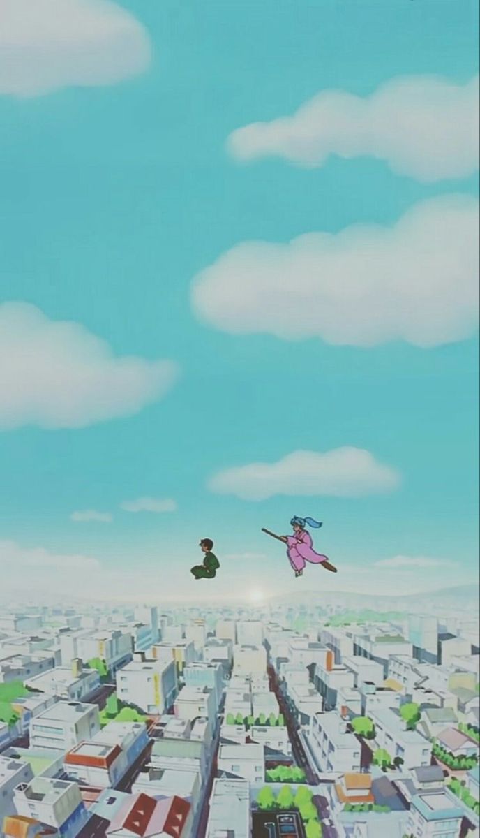 two people flying through the air over a city