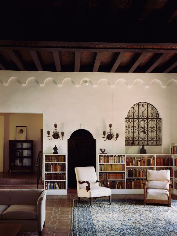 a living room filled with furniture and bookshelves