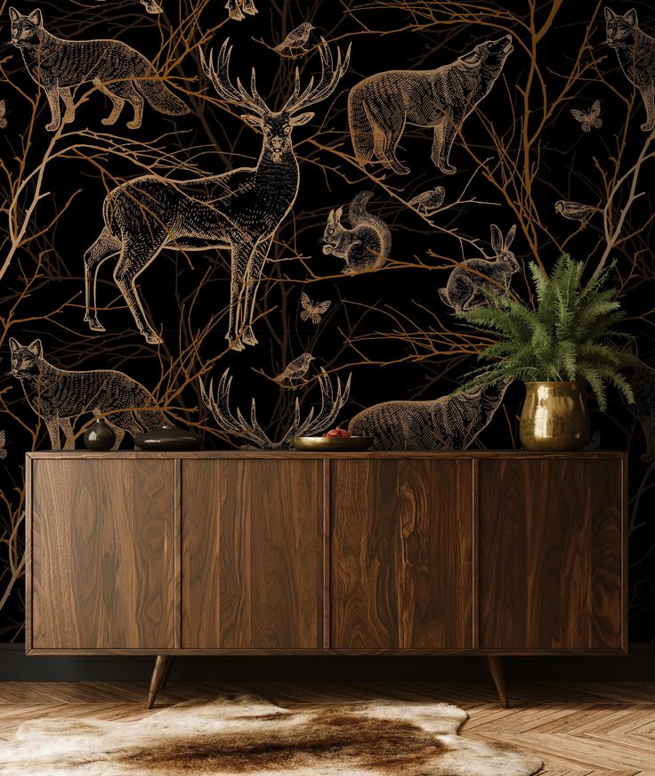 an animal themed wallpaper with deers and other animals on the sideboard in front of it