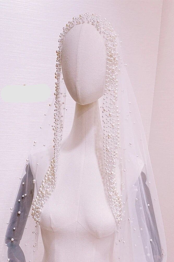 a mannequin wearing a veil with pearls on it