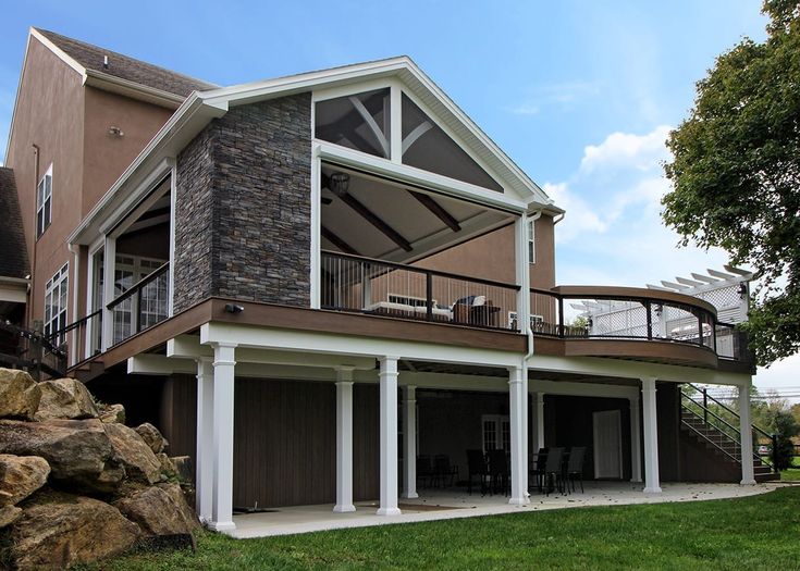 a large house with an attached deck and covered patio