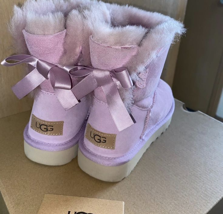 Purple Aesthetic Shoes, Purple Girly Things, Lavender Uggs, Trendy Purple Winter Boots, Lavender Ugg Slides, Purple Ugg Boots, Pink Uggs With Bows, Purple Uggs, Baily Bow Pink Uggs