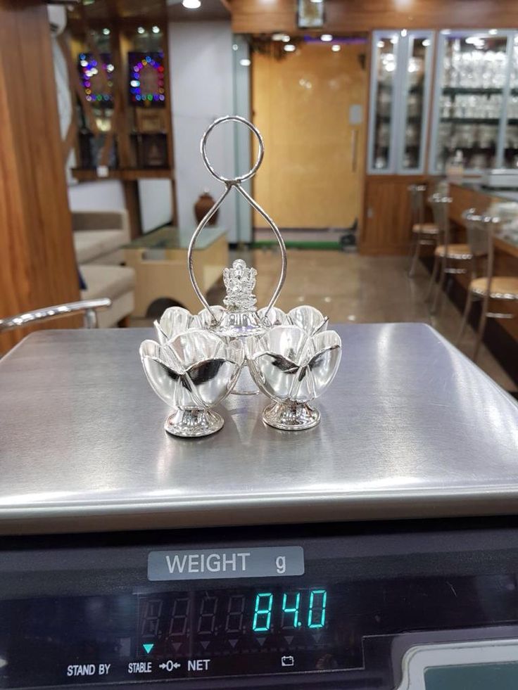 a scale with a glass figurine sitting on top of it