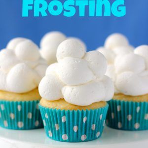 cupcakes with white frosting sitting on a cake stand