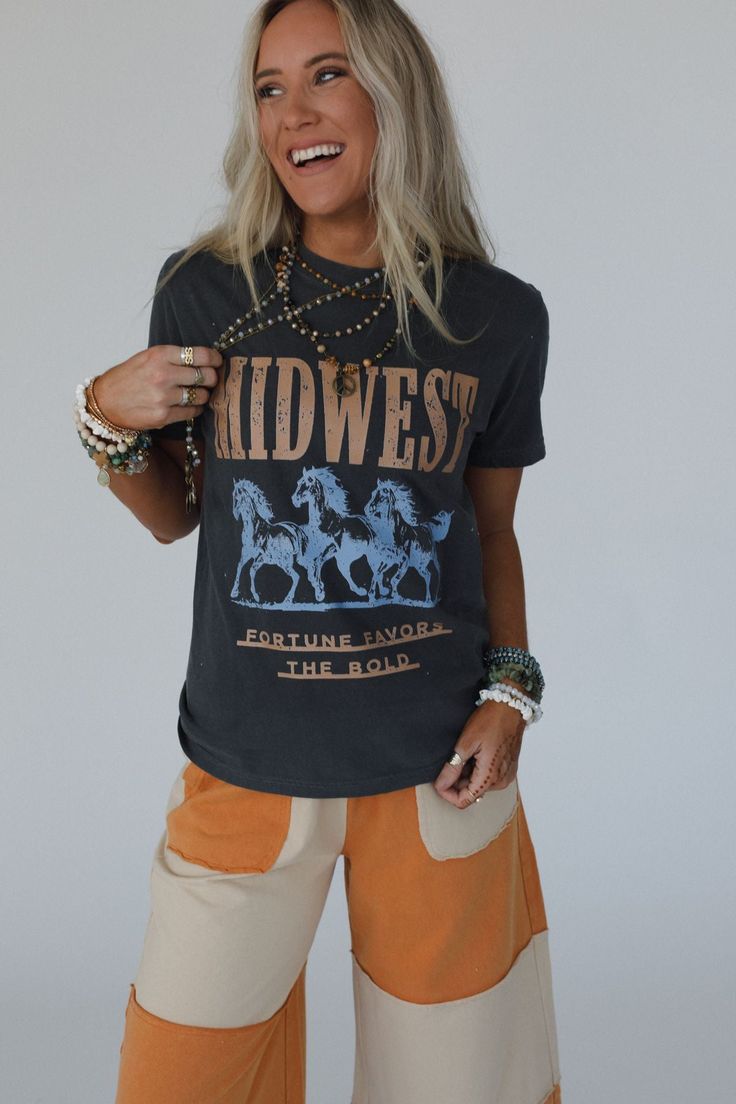 No boho closet is complete without the perfect graphic tee, and the Midwest Fortune Graphic Tee is it! So cool, you won’t want to miss out! Comfortable, mineral-washed, Cotton tee shirt fabric Relaxed and slouchy silhouette for ultimate comfort Classic crew neckline with dropped shoulders and loose short sleeves So cool Western Inspired Running Wild Horses with "MIDWEST - Fortune Favors the Bold" print Pair with: Eye Of The Sun Padded Bralette, The Signature Flare and Shoreline Platform Sandals. Bohemian Acid Wash Short Sleeve Tops, Stonewashed Graphic Tee For Spring, Bohemian Crew Neck Washed Tops, Bohemian Washed Crew Neck Tops, Bohemian Acid Wash Crew Neck Top, Acid Wash Bohemian Short Sleeve Tops, Vintage Stonewashed Tops For Fall, Stonewashed Crew Neck T-shirt For Spring, Faded Graphic Print Top For Fall