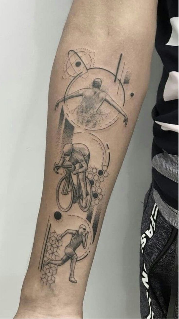 a person with a tattoo on their arm that has an image of a man riding a bike