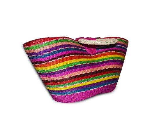 Multicolor beach handbag made of woven palm with twin handles and velcro strap. 17.75 in tall, 9.5 in length and 7.5 in width.Palm baskets and other woven palm products represent one of Mexico's oldest traditional crafts. All woven items are produced by hand by local basket crafters in the villages throughout Mexico where an abundance of palm groves are found. Multicolor Woven Straw Bag For Travel, Multicolor Bucket Straw Bag With Handles, Multicolor Straw Beach Bag For Shopping, Multicolor Rectangular Straw Bag For Beach Season, Multicolor Woven Shoulder Bag For Summer, Traditional Multicolor Bags For Vacation, Multicolor Woven Beach Bag For Vacation, Multicolor Bucket Straw Bag For Beach, Multicolor Straw Bucket Shoulder Bag