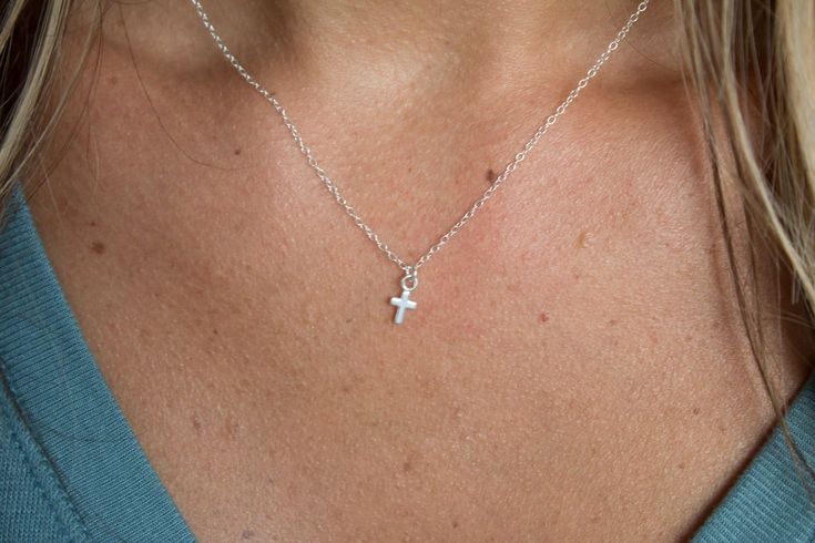 Sterling Silver Mini Small Cross Necklace, Tiny Cross Necklace, Tiny Charm Dainty Necklace, Thin Chain Necklace, Gift for Her Material: 925 Sterling silver. High quality! Chain: 16 inch (can be adjusted upon request). Model is wearing 16" Cross Charm: 4.6x8.6mm If you have any questions, don't hesitate to contact me I will be more than happy to work with you on any custom orders or making the changes or improvements to my original designs. LARGER quantities are available. I take pride in my work. I pay close attention to the details of each handcrafted piece. Moreover, I ensure the good quality, replacement or repair. -------------------------------------------------- -------------------------------------------------- To exit to boutique for more great buys: http://www.etsy.com/shop/Elegan Small Cross Necklace, Dainty Cross Necklace, Tiny Cross Necklace, Tiny Cross, Tiny Charm, Amethyst Gold, Small Crosses, Necklace Online, Cross Charms