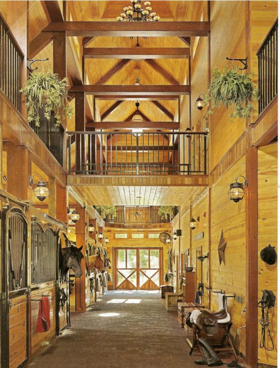 the inside of a horse barn with wooden walls