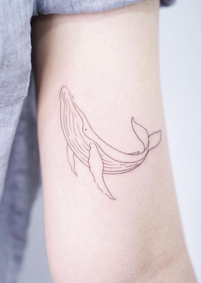 a small whale tattoo on the right thigh