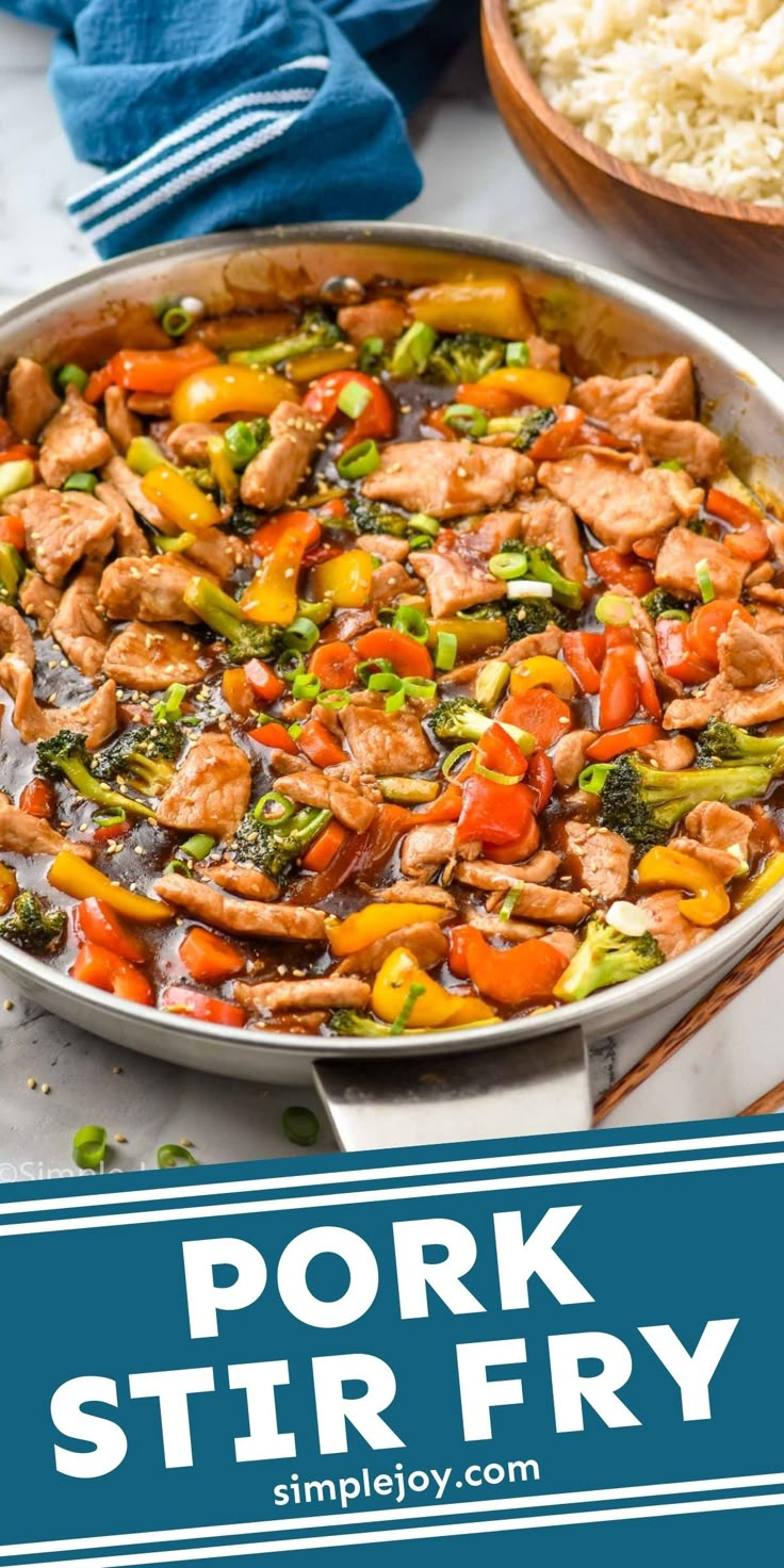 pork stir fry in a pan with vegetables and rice