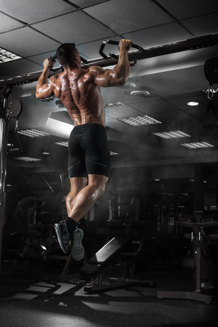 a man doing pull ups in the gym