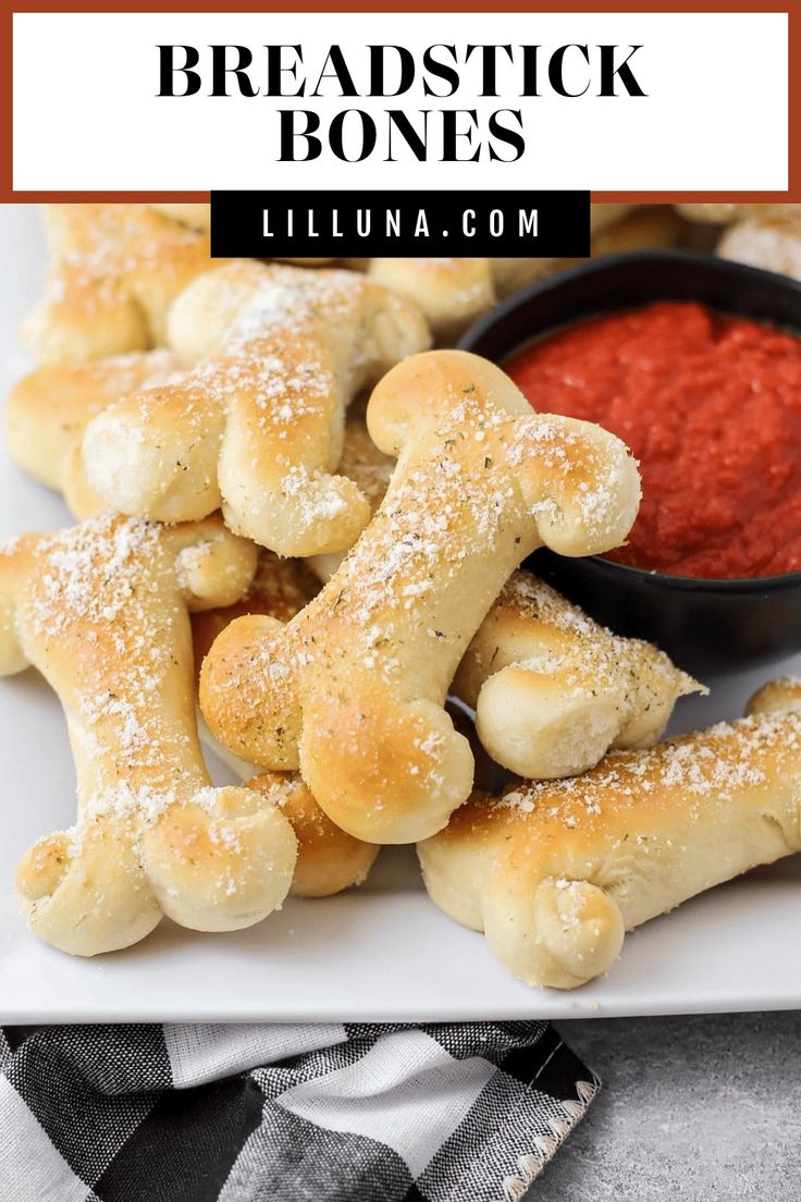 breadsticks with dipping sauce and dog bones on a plate for dogs to eat