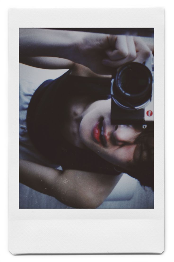 a polaroid photo of a woman holding a camera