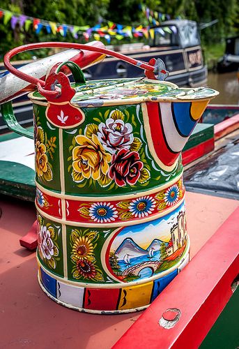 a colorful bucket sitting on top of a boat